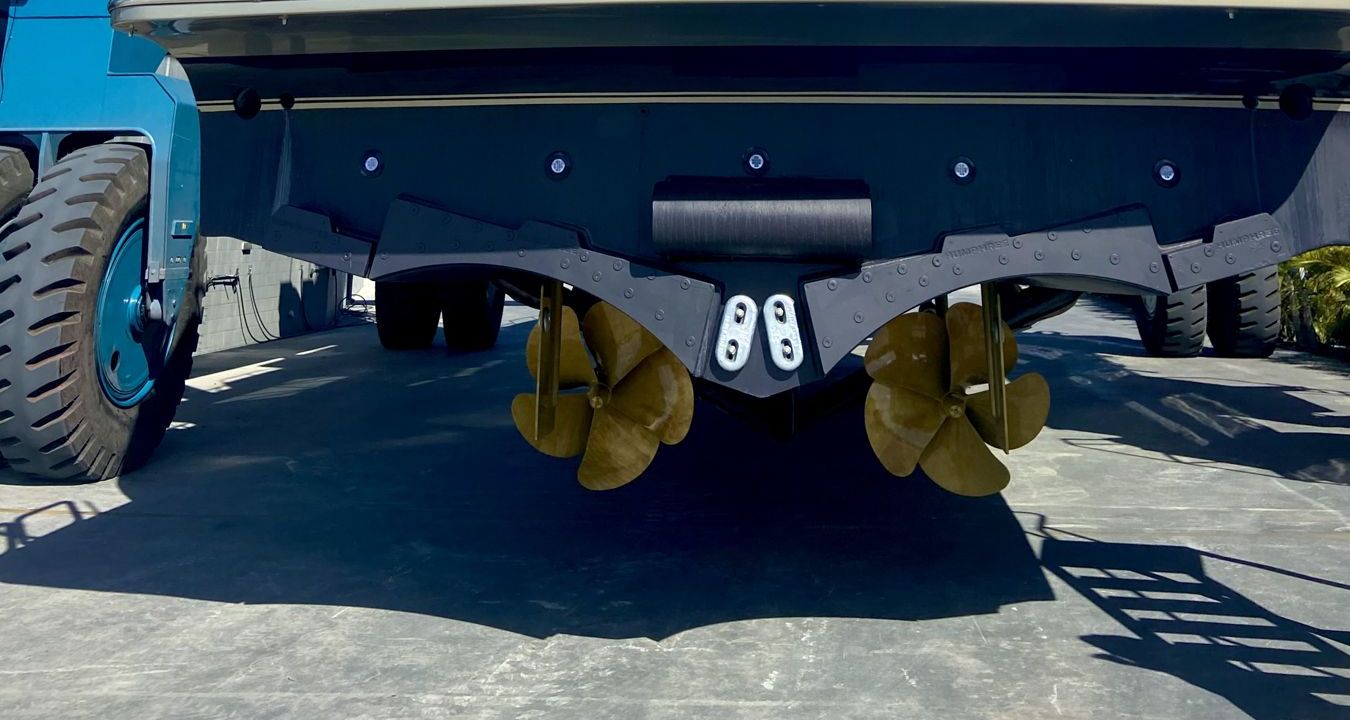 The underwater hull, tunnel and twin propellers of a motor yacht in the travel lift